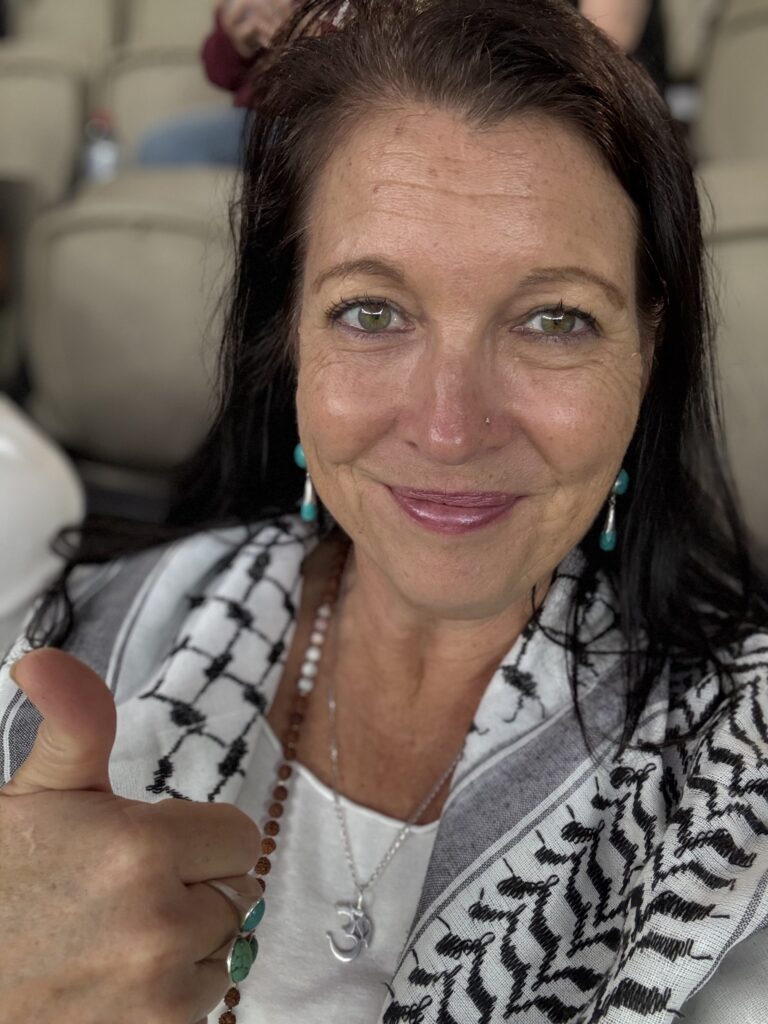 Natalie Snooke wearing keffiyeh, a traditional Palestinian scarf